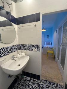 a bathroom with a sink and a mirror at La Marina - Casa al Mare in Nerano