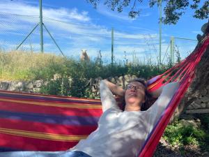 a woman is laying in a hammock at Finca Son Manera in Montuiri