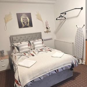 a bedroom with a bed with a lamp on the wall at Bv Charming Studio with Free Private Parking, 10 Minutes from Town Centre in Huddersfield