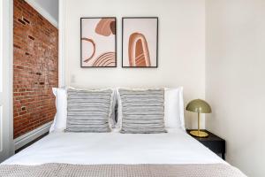 a bedroom with a white bed with two pillows at Nolita 1br w wd nr New Museum NYC-1037 in New York