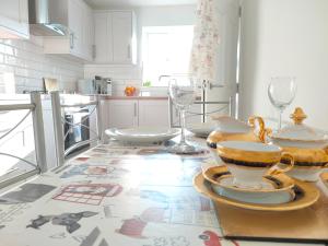 una cocina con una mesa con platos y vasos. en Cosy Family Home in Long Eaton, Nottingham, en Nottingham