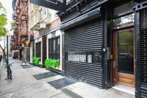 an empty street with a store front with closed doors at Nolita 1br w wd nr New Museum NYC-1037 in New York