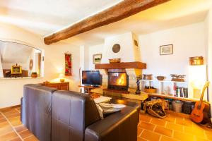 a living room with a couch and a fireplace at VILLA ROCHE GRISE - Berre-les-Alpes in Berre-des-Alpes