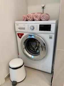 a washing machine with towels on top of it at Modern Lux Apartment with Great View in Tallinn