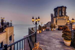 a boardwalk with lights and a building and the ocean at Gold Coast studio w doorman gym 2 blocks to L CHI-916 in Chicago