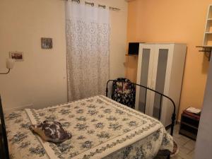 a room with a bed with a table and a refrigerator at Sweet Night in Perugia