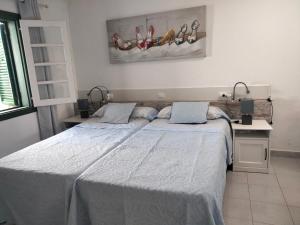 a bedroom with a large bed with two pillows at Puerta del sol in Caleta De Fuste +31 photos