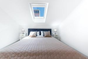 a bedroom with a bed and a window at Deluxe Cosmopolit apartment in Cavtat