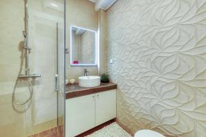 a bathroom with a shower and a sink at Deluxe Cosmopolit apartment in Cavtat
