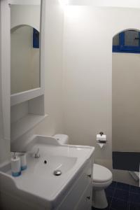 a bathroom with a white sink and a toilet at Evelia Sea House in Plimmiri