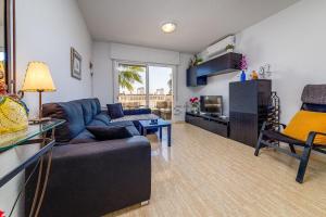 a living room with a couch and a table at Aguamarina Playa in Orihuela