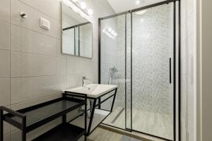 a bathroom with a sink and a shower at PARK Apartmanok in Balatonszárszó