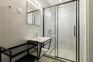 a bathroom with a sink and a shower at PARK Apartmanok in Balatonszárszó +54 photos