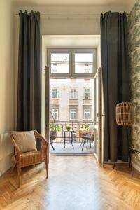 a living room with a door open to a balcony at Modern Apartments Piłsudskiego Street in Krakow
