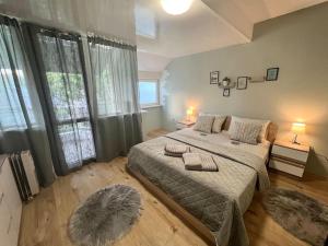 Un dormitorio con una cama grande y una ventana grande. en Център Варна апартамент с паркинг за нормална до средно голяма кола, en Varna