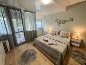 Un dormitorio con una cama grande y una ventana grande. en Център Варна апартамент с паркинг за нормална до средно голяма кола, en Varna