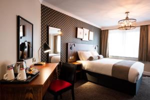 a hotel room with a bed and a desk at Miller & Carter Sheffield by Innkeeper's Collection in Sheffield