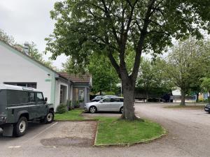 a car parked next to a tree in a driveway at The Kiln Hotel, Wakefield West Yorkshire, Part of the AG Collection in Wakefield