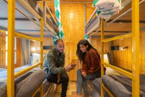 Ein Mann und eine Frau stehen in einem Etagenbett in der Unterkunft Whoopers Boutique Kasol in Kasol