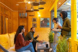 a group of people talking in a room at Whoopers Boutique Kasol in Kasol
