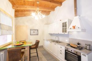 a kitchen with white cabinets and a sink and a counter at Ca' de la Gondola, Murano in Venice