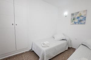 Łóżko lub łóżka w pokoju w obiekcie Apartamento Loli