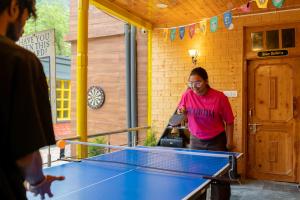 a man standing in front of a ping pong table at Whoopers Boutique Kasol in Kasol