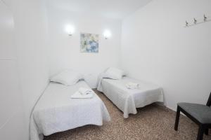 Łóżko lub łóżka w pokoju w obiekcie Apartamento Loli