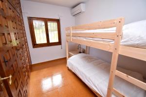 a bedroom with two bunk beds and a window at Casa Vista Montgo Javea - 5048-1 in Balcon del Mar