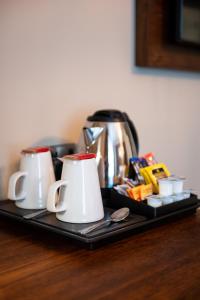 a tray with two coffee mugs and a coffee pot at Miller & Carter Sheffield by Innkeeper's Collection in Sheffield