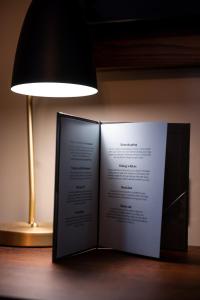 a book sitting on a table next to a lamp at Miller & Carter Sheffield by Innkeeper's Collection in Sheffield