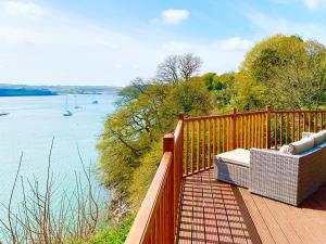 a wooden deck with a view of a body of water at Badger Lodge in Burton