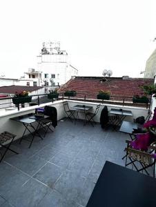 Un balcón con mesas y sillas en un edificio en Mr Miller Suites, en Estambul