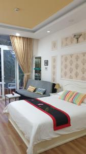 a bedroom with a large bed with a large window at CHEZ LOTUS VN in Ho Chi Minh City