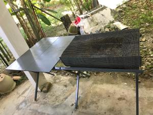 a black bench sitting on top of a table at Simple1 Guesthouse in Pantai Cenang