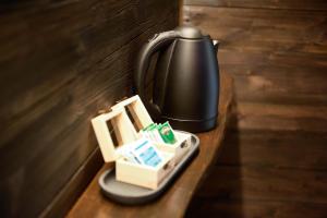 a black tea kettle sitting on a wooden table at Narciso Home in Adrara San Rocco