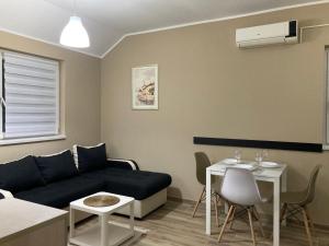 a living room with a couch and a table at Apartman Jany in Kijevo