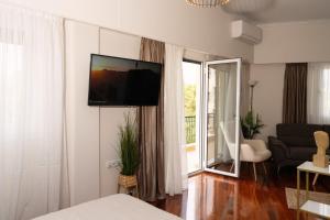 a living room with a flat screen tv on a wall at Visum Acropol ,3BR - Private Terrace-Jacuzzi - Amazing View in Athens