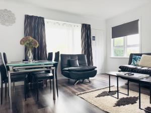 a living room with a table and chairs and a couch at A1 Kaikoura Motel & Holiday Park in Kaikoura