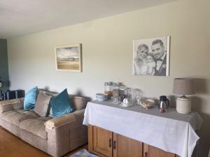 a living room with a couch and a table at Camino House in Tralee