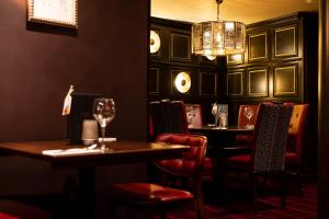 a restaurant with two tables and chairs and a chandelier at Miller & Carter Sheffield by Innkeeper's Collection in Sheffield