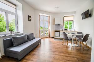 a living room with a couch and a table at Guesthouse Pr'Šefu in Brežice