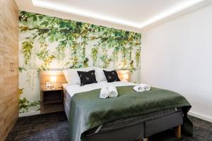 a bedroom with a bed with towels on it at PARK Apartmanok in Balatonszárszó