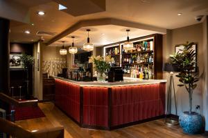 a bar in a restaurant with a red counter at Miller & Carter Sheffield by Innkeeper's Collection in Sheffield +37 photos