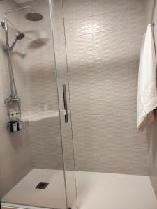 a shower with a glass door in a bathroom at ATICO CALDAS in Caldas de Reis