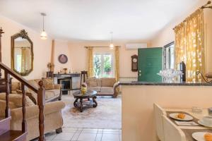 a kitchen and living room with a counter top at Villa Armeni by CorfuEscapes in Corfu Town