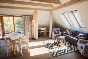 a living room with a table and a couch at Lijo in Gargždai