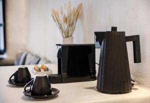 a coffee maker sitting on a counter in a room at One of One - Aurelia in Oia