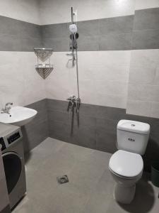 a bathroom with a toilet and a sink at Sommer by Sveta / Лето у Светы in Ureki