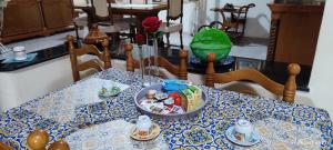 a dining room table with a blue and white table cloth at ToMa House in Pellaro